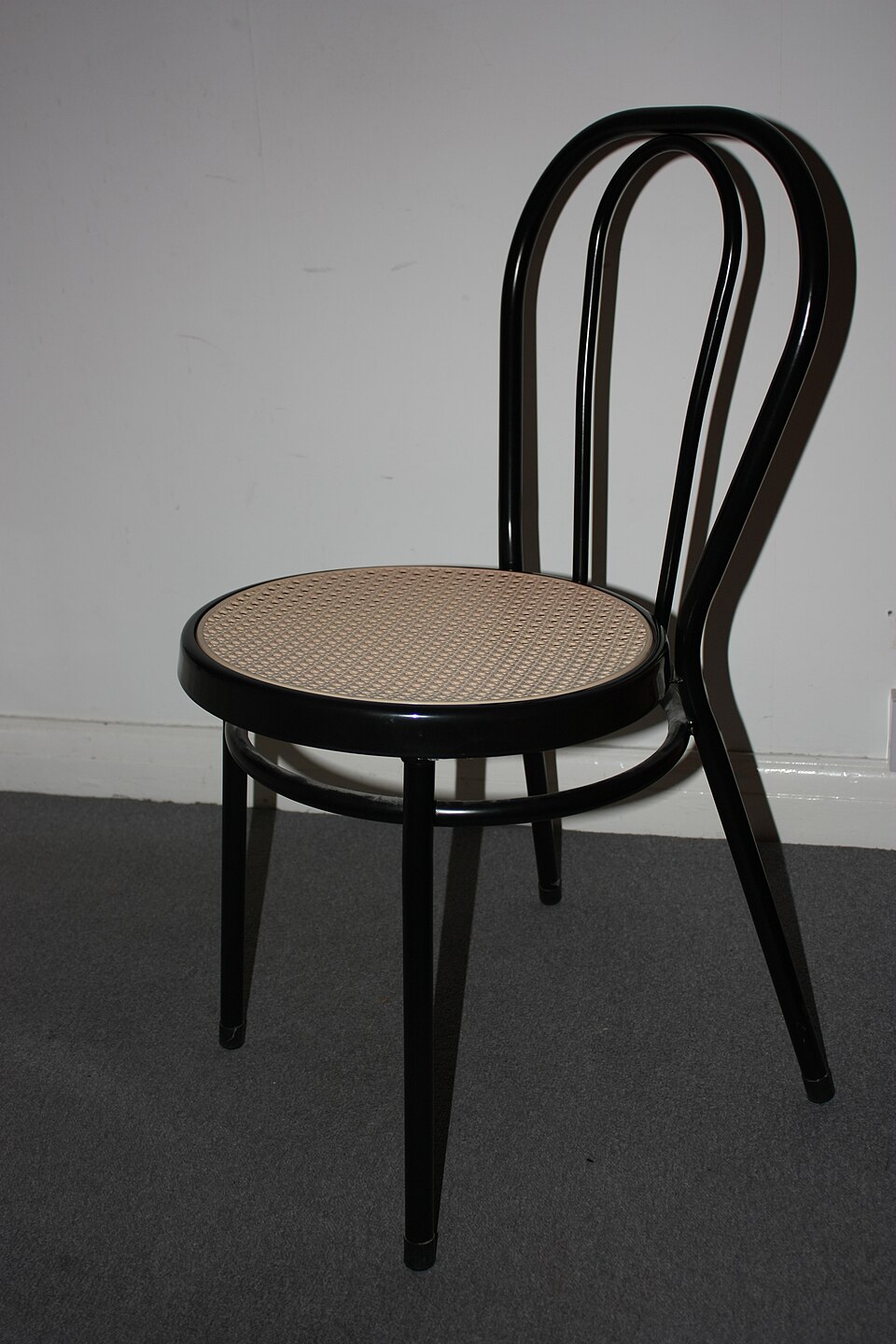 A bentwood chair against a plain wall; sample photo by Antonio Borrillo